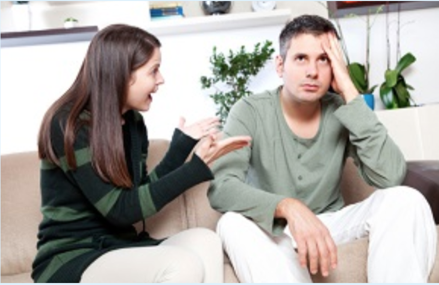 a woman and man sitting on a couch