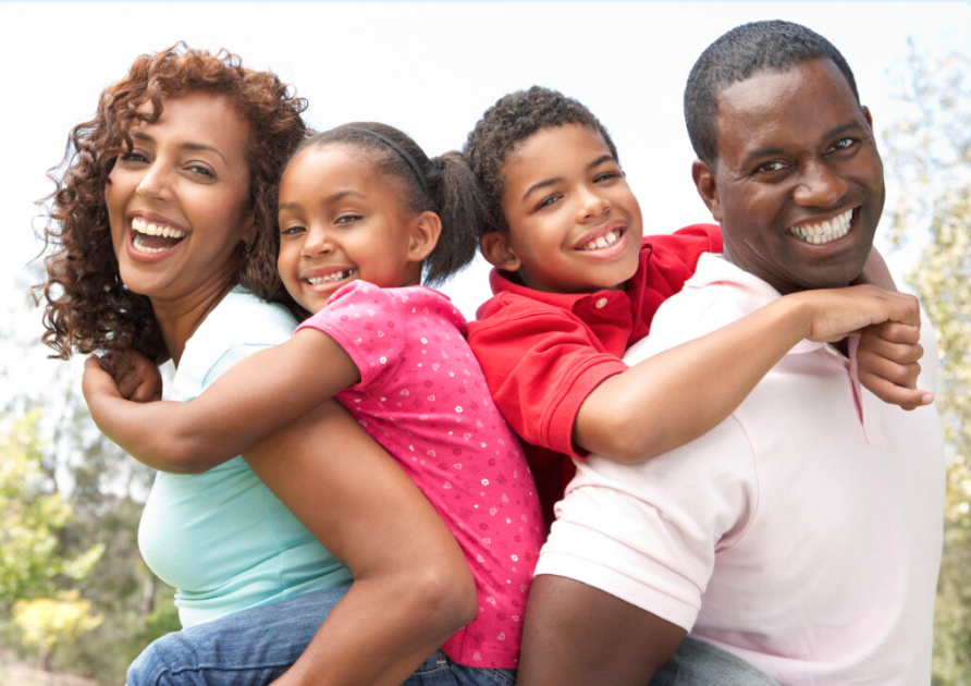 a man and woman piggybacking children